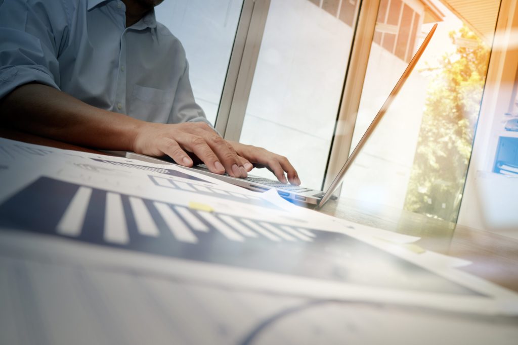 business documents on office table with smart phone and laptop c
