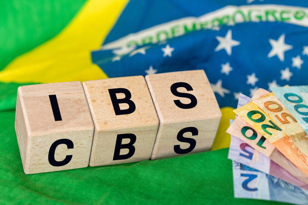 Brazil Finance and taxes. IBS and CBS written on a wooden block IBS. Concept, Brazilian tax reform, simplification of VAT in two local IBS fees for goods and services and the Federal CBS contribution.